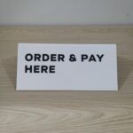 Sign Board Akrilik “Order & Pay Here”: Solusi Modern untuk Kemudahan Pelanggan
